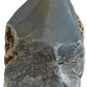 Natural rough angelite freeform with polished point 3 sians emporium Natural rough angelite freeform crystal with unpolished sides and a smooth polished blue point standing on a white background